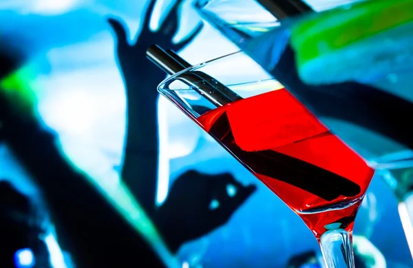 Detail of blue and red cocktail drink on a disco table with space for text — Stock Photo, Image