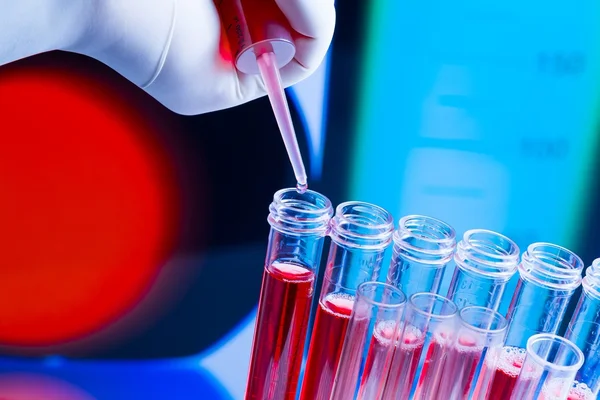 Test tubes with pipette on red liquid in laboratory — Stock Photo, Image