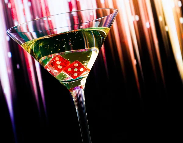 Red dice in the cocktail glass on colorful gradient with space for text — Stock Photo, Image