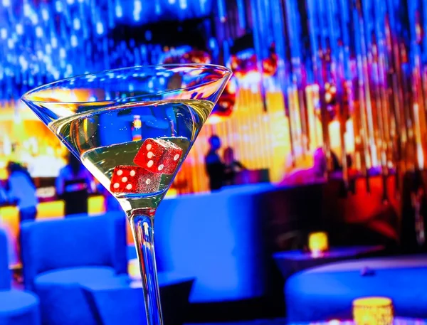 Dadu merah dalam gelas koktail di depan kasino lounge bar — Stok Foto