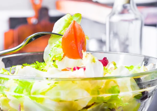 Detail of fork on italian fresh salad with tomato on kitchen — Stock Photo, Image