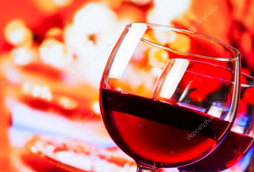 detail of red wine glasses against unfocused restaurant table background
