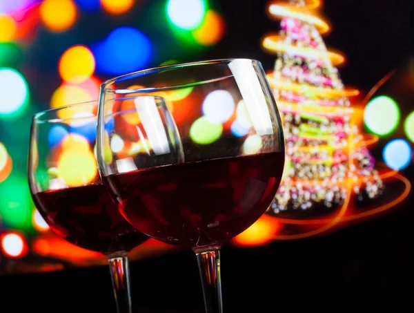 Red wine glass against bokeh lights tree background — Stock Photo, Image