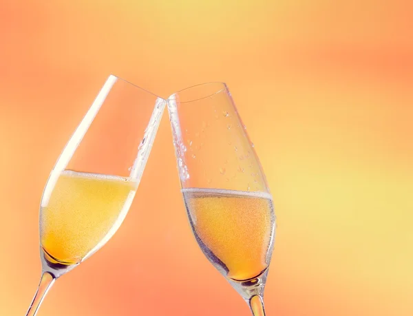 Two flutes of champagne with golden bubbles and space for text — Stock Photo, Image