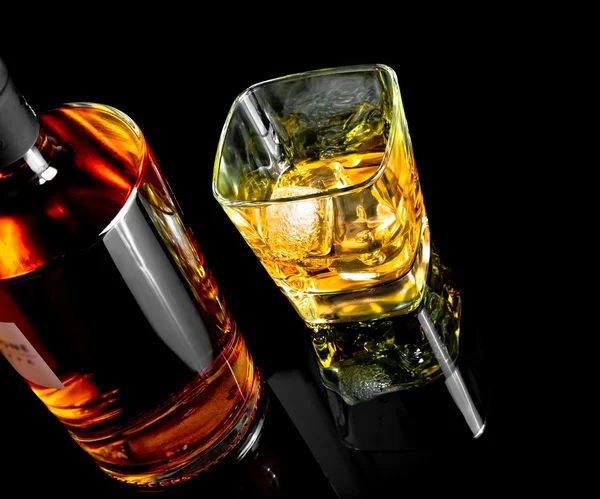 Top of view of whiskey with ice in glass on black background — Stock Photo, Image