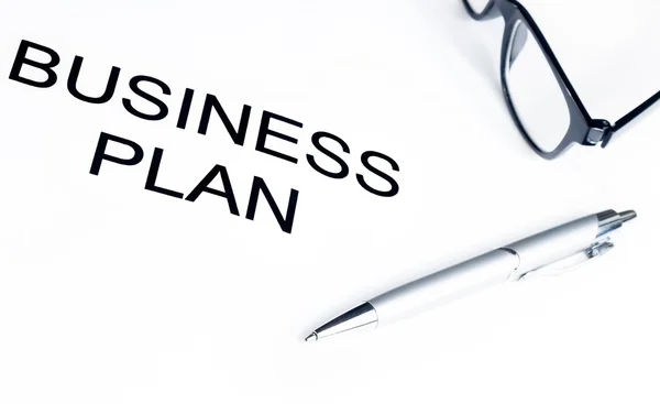 Business plan words near glasses and pen, business concept — Stock Photo, Image