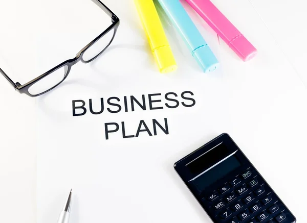 Business plan words near highlighters, calculator and glasses, business concept — Stock Photo, Image