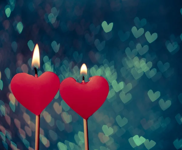 Rote Herzen Kerzen auf Vintage-Herzen bokeh als Hintergrund — Stockfoto