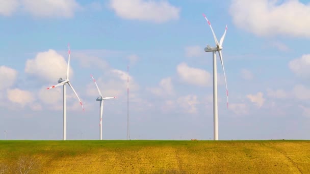 Wind energy turbines are one of the cleanest, renewable electric energy source, under blue sky with white clouds — Stock Video