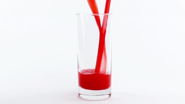 Pouring red orange juice isolated into glass on white background — Stock Video