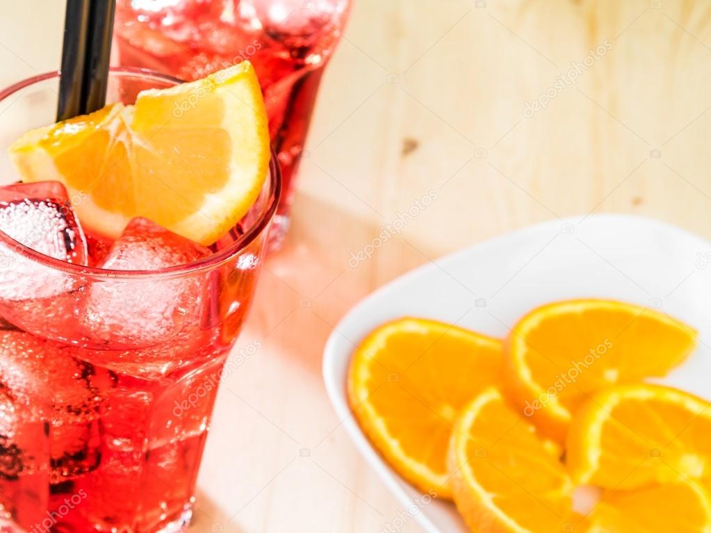 top of view of glass of spritz aperitif aperol cocktail with orange slices and ice cubes