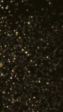 Altın parıltılı baloncuk parçacıkları siyah zemin üzerinde boekh, şenlikli yeni yıl tatili konsepti, akıllı telefon