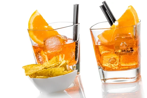 Hot tacos chips in front of two glasses of spritz aperitif aperol cocktail with orange slices and ice cubes — Stock Photo, Image