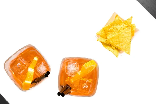 Top of view of hot tacos chips near two glasses of spritz aperitif aperol cocktail with orange slices and ice cubes — Stock Photo, Image