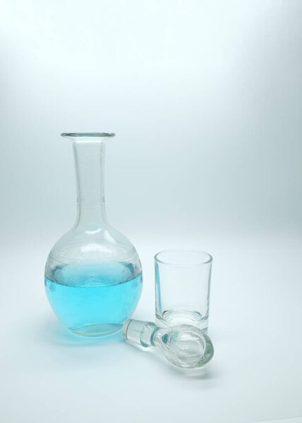 blue alcoholic drink in a decanter. Cocktail with blue gin on a white background