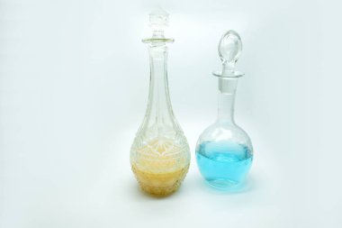 two bottles with bright color fruit lemonade, blue yellow special painted bar drinks. three bottles of liquor blue red and yellow