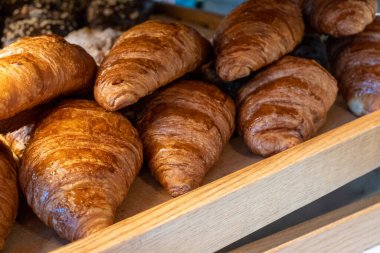 Delicious croissants on the store showcase of the bakery house. croissant showcase