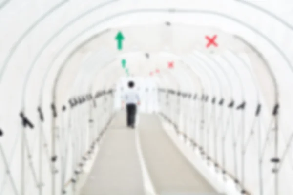 Blur or Defocus image of Man walking under the tunnel of Canvas