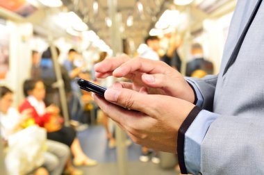 Business Man using Mobile Phone in Train