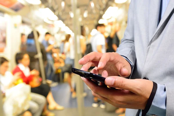 Business Man using Mobile Phone in Train