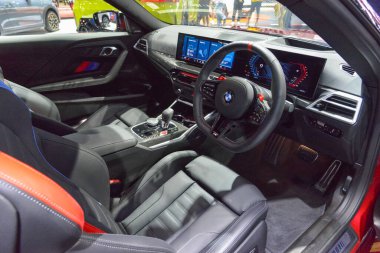 Bangkok-March 24,2025 : interior cockpit of The New BMW M2 displayed at an international motor show in Bangkok, Thailand. High-performance sports coupe cabin featuring M steering wheel, digital instrument cluster, widescreen infotainment display, pre