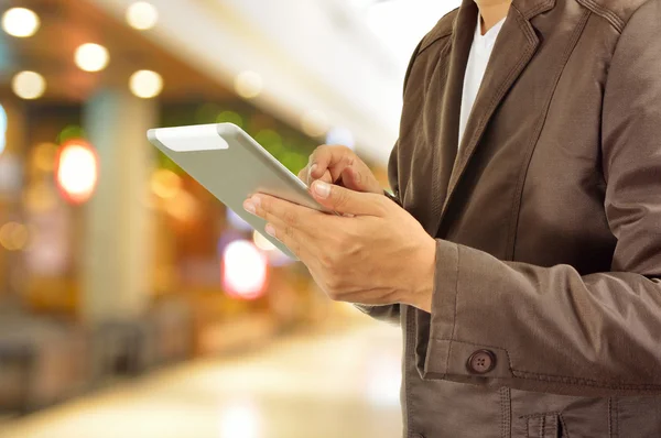 Young Man Hands holding Tablet in Shopping Mall