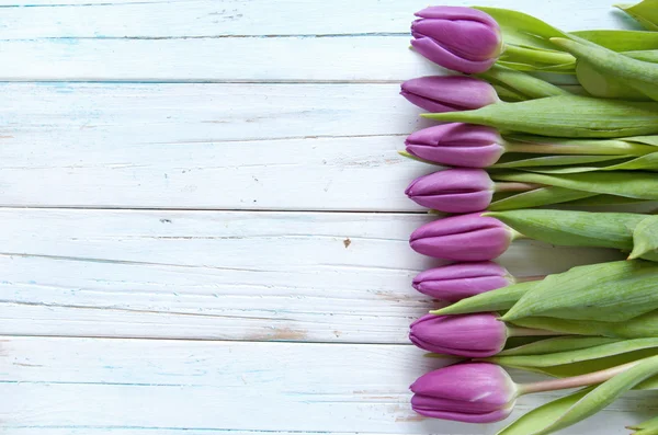 Tulips on a wooden background — Stock Photo, Image