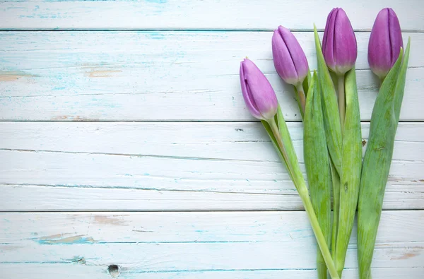 Tulips on wooden background — Stock Photo, Image