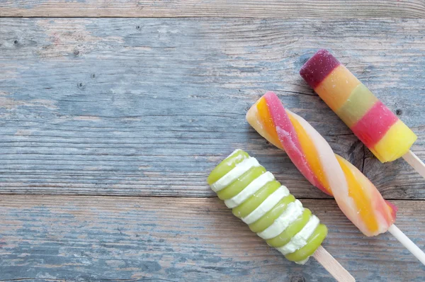 Ice lollies on a wooden background — Stock Photo, Image