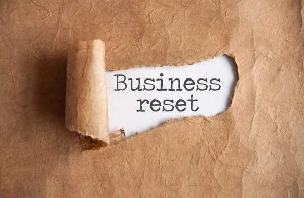 Torn Piece Scroll Revealing Business Reset — Stock Photo, Image