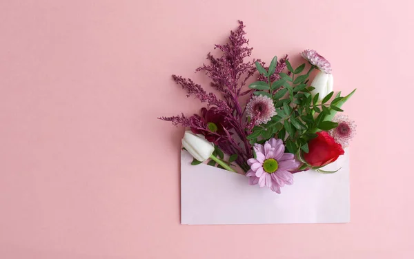 Assorted flowers inside an envelope closeup