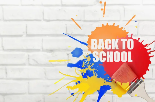 Back to school paint splash stencil with brush on brick wall