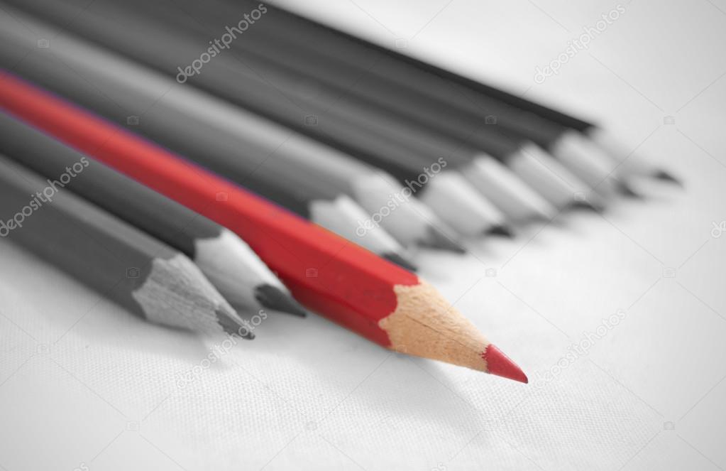 Unique pencil amongst a row of pencils