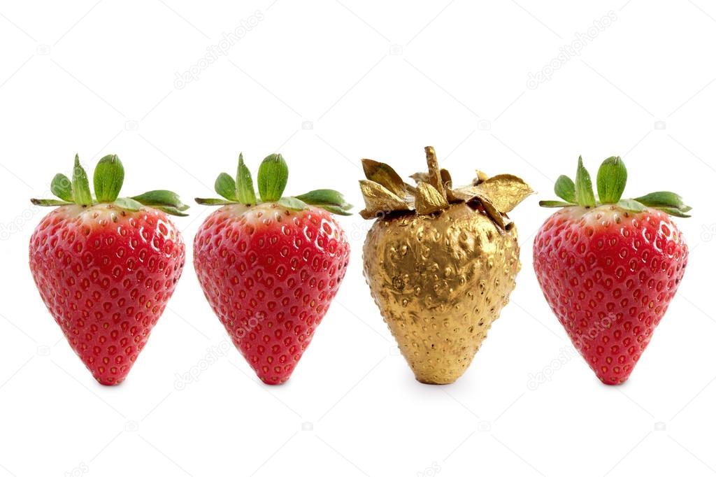 Gold strawberry among of red berries