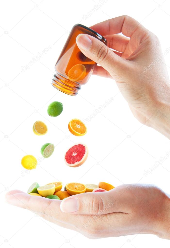 Citrus fruits pouring out of a vitamin