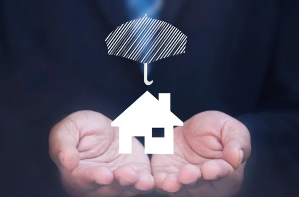 Business man holding a house icon — Stock Photo, Image