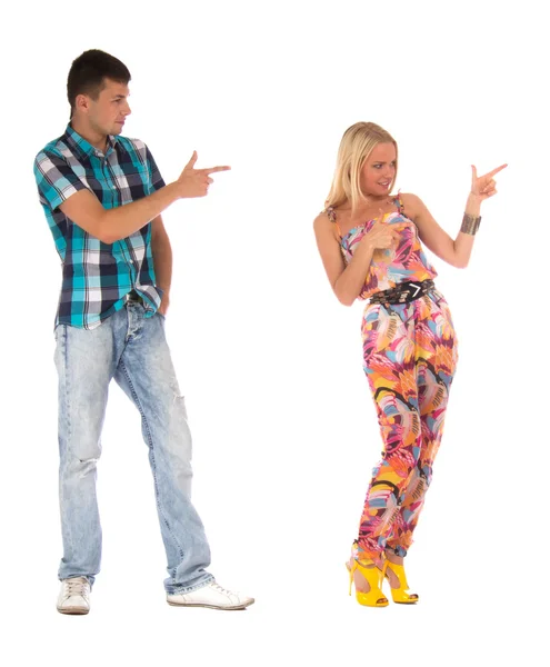 Happy emotional teenage couple pointing — Stock Photo, Image