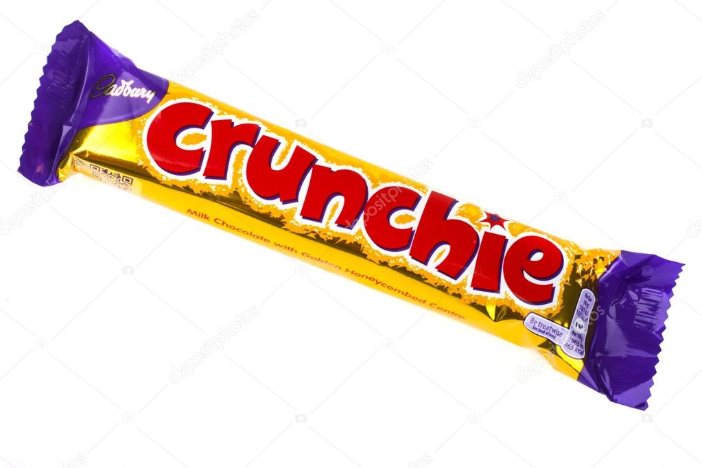 LONDON, UK - JUNE 16TH 2016: An unopened Crunchie chocolate bar manufactured by Cadbury, pictured over a plain white background on 16th June 2016.