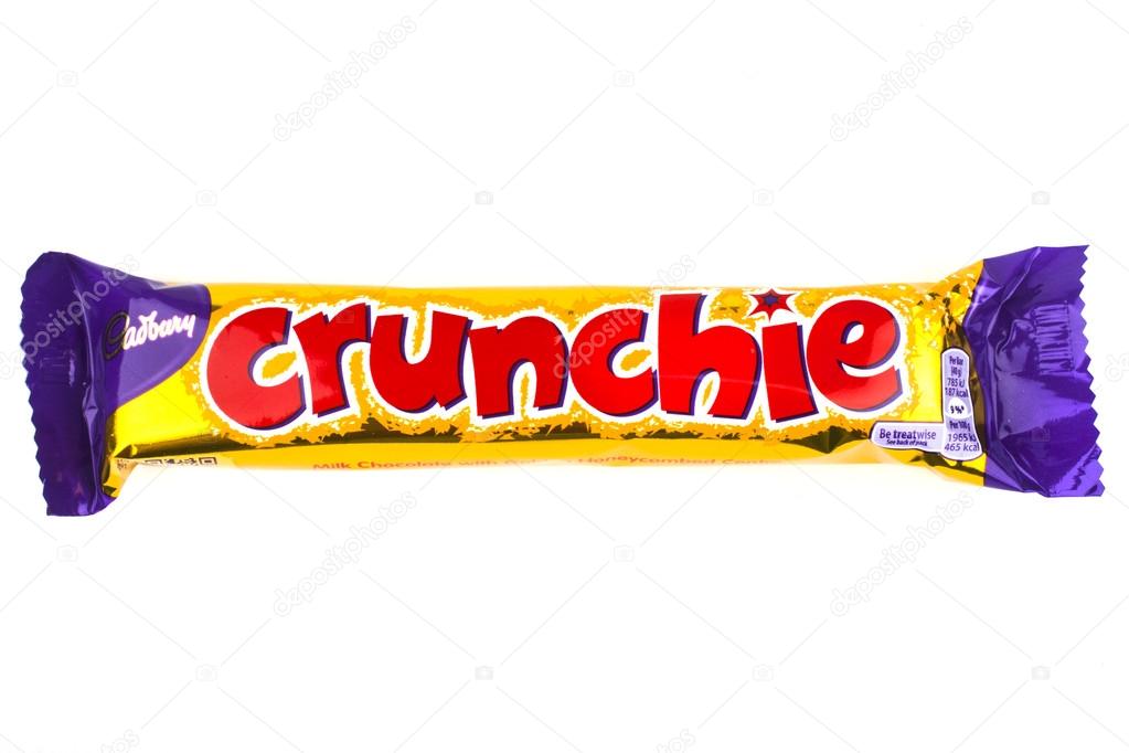 LONDON, UK - JUNE 16TH 2016: An unopened Crunchie chocolate bar manufactured by Cadbury, pictured over a plain white background on 16th June 2016.