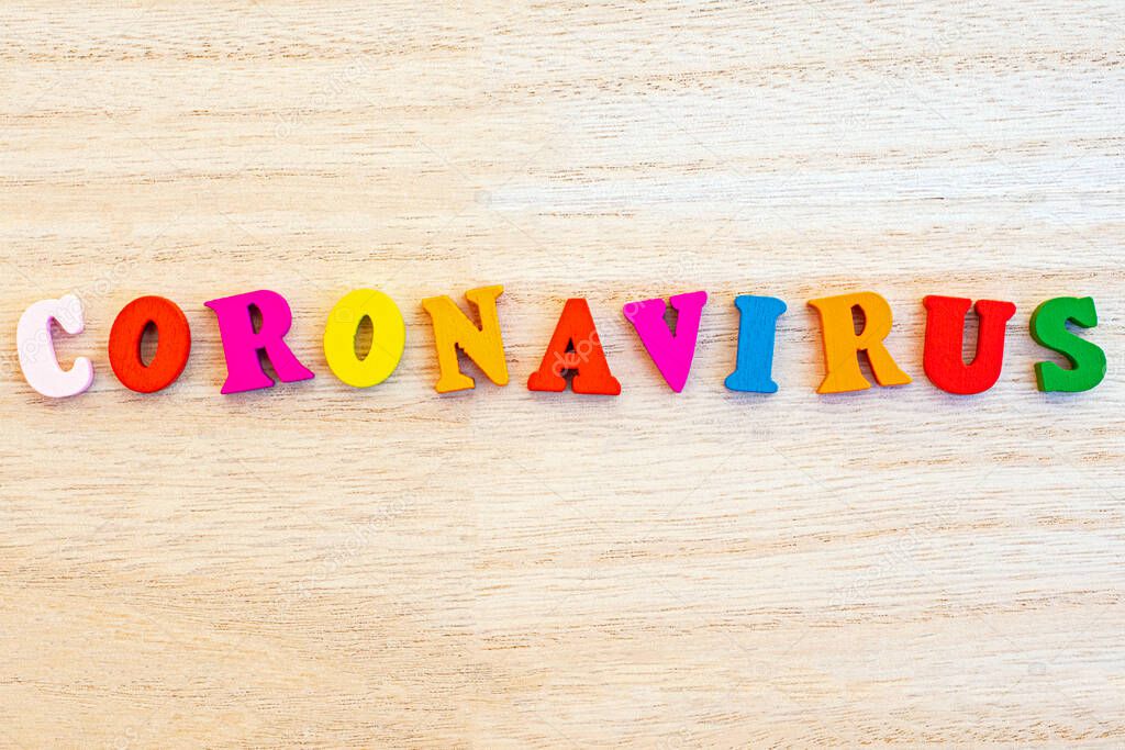 The word CORONAVIRUS spelt with colourful wooden letters.