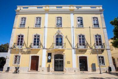 Lagos, Portekiz - 23 Eylül 2025: Portekiz 'in Algarve kenti Lagos' taki Praca Gil Eanes 'de eski bir belediye binasının dış cephesi. Bina şu anda bölge polisi ve turist bilgilerine ev sahipliği yapıyor..