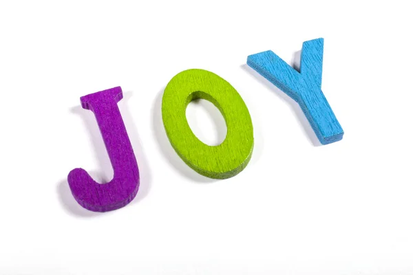 JOY spelt out with bright coloured letters — Stock Photo, Image