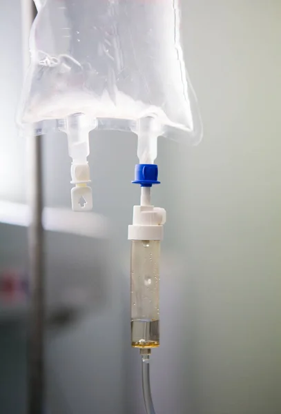 Fluid running from a drip in a hospital to be administered to a patient