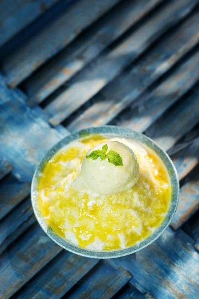 Coconut sorbet with mango sauce and vanilla ice cream — Stock Photo, Image