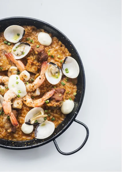 Spanish seafood and rice paella risotto on white background — Stock Photo, Image