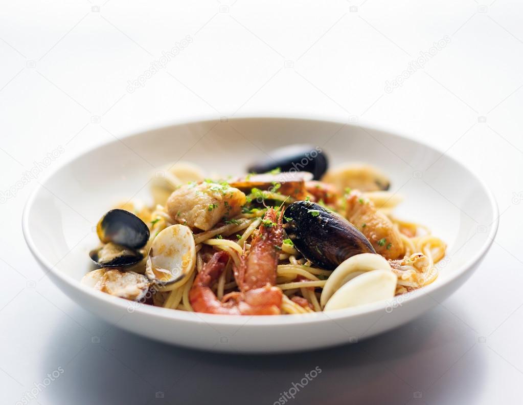Seafood and spicy puttanesca marinara tomato pasta Stock Photo by