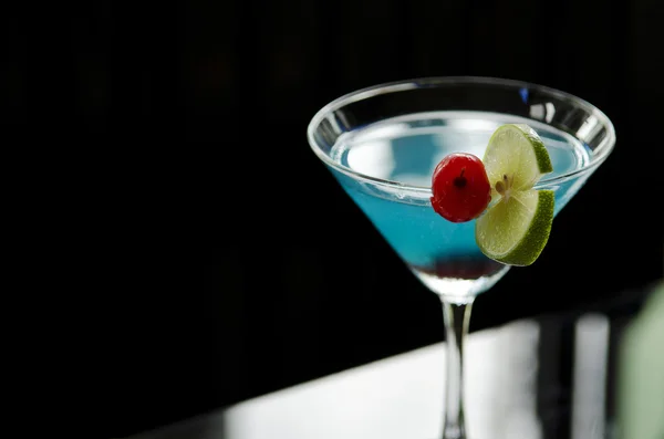 Blue cocktail with cherry and lime — Stock Photo, Image
