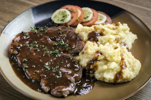 Beef steak meal with mashed potato and gravy sauce — Stock Photo, Image