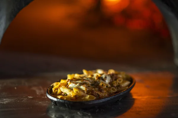 Baked penne pasta bolognese with cheese — Stock Photo, Image