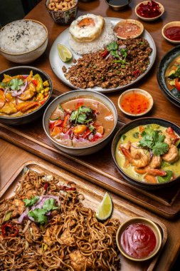 mixed traditional cuisine popular thai food dishes on bangkok restaurant table indoors